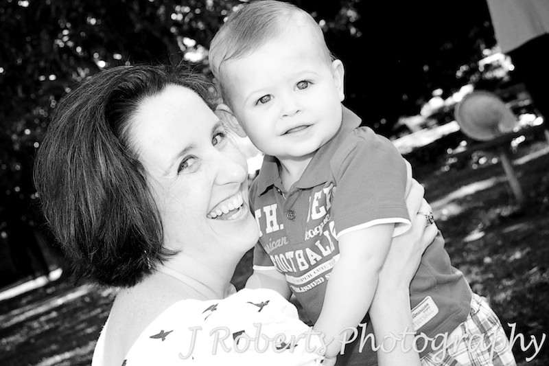 B&W of little boy laughing with his mother - family portrait photography sydney